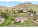 Expansive single-story home showcasing well-kept lawn, mature trees, and mountainous scenery at 4305 Easley Rd, Golden, CO 80403