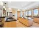 Spacious kitchen with tile floors, large island, and stainless refrigerator at 4305 Easley Rd, Golden, CO 80403