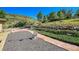 Backyard featuring gravel landscaping, lawn, stone patio, and mountain views at 5808 Crestbrook Cir, Morrison, CO 80465
