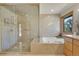 Bathroom features a glass enclosed shower, garden tub, and natural light at 5808 Crestbrook Cir, Morrison, CO 80465