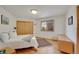 A bright bedroom featuring wood floors, a closet, and an outside view at 5808 Crestbrook Cir, Morrison, CO 80465