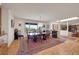 Spacious dining area with a large rug, wood floors, and a clear view into the living room at 5808 Crestbrook Cir, Morrison, CO 80465