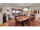 Elegant dining room features a large window with mountain views, a modern light fixture, and wood furnishings at 5808 Crestbrook Cir, Morrison, CO 80465