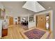 Open-concept foyer featuring hardwood floors, a skylight, stained-glass door and a dining area at 5808 Crestbrook Cir, Morrison, CO 80465
