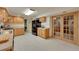 Traditional kitchen with wood cabinets, neutral counters and flooring, black appliances, and glass paneled doors at 5808 Crestbrook Cir, Morrison, CO 80465