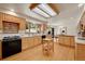 Well-lit kitchen features custom cabinets, granite countertops, and modern appliances for a stylish cooking experience at 5808 Crestbrook Cir, Morrison, CO 80465