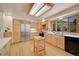 Bright kitchen featuring custom cabinets, a kitchen island and black appliances at 5808 Crestbrook Cir, Morrison, CO 80465
