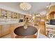 Spacious kitchen with natural wood cabinetry, central island, and dining nook at 5808 Crestbrook Cir, Morrison, CO 80465