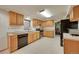 Classic kitchen with wood cabinets, tile backsplash, stainless steel appliances, and tile flooring at 5808 Crestbrook Cir, Morrison, CO 80465