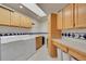 Well-lit laundry room with washer, dryer, cabinets, and skylight at 5808 Crestbrook Cir, Morrison, CO 80465