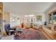 Bright and airy living room with hardwood floors, comfortable seating, and large windows at 5808 Crestbrook Cir, Morrison, CO 80465