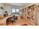 Home office with custom built-in shelves and a large window with a serene view at 5808 Crestbrook Cir, Morrison, CO 80465