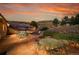 Paver patio with outdoor seating, landscaping, and sunset views at 5808 Crestbrook Cir, Morrison, CO 80465