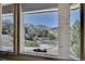 A beautiful view of the landscape through a large window, with a glimpse of the paved driveway at 5808 Crestbrook Cir, Morrison, CO 80465