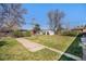 Lush backyard with green grass, a walkway, and mature trees at 241 S 15Th Ave, Brighton, CO 80601