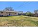 Expansive backyard features a well-maintained lawn and a charming brick home exterior at 241 S 15Th Ave, Brighton, CO 80601