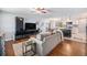 Open-concept living room with hardwood floors seamlessly integrates with a modern kitchen at 241 S 15Th Ave, Brighton, CO 80601