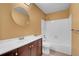 Bathroom with white tile shower-tub, dark vanity and white countertop at 2181 S Troy Way # 103, Aurora, CO 80014
