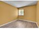 Bright bedroom with hardwood floors, yellow walls, and a window for natural light at 2181 S Troy Way # 103, Aurora, CO 80014