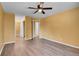 Bedroom with wood floors, ceiling fan, closet and bathroom access at 2181 S Troy Way # 103, Aurora, CO 80014