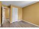 Bedroom with neutral walls, wood-look flooring, and white trim at 2181 S Troy Way # 103, Aurora, CO 80014