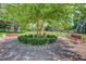 Beautifully landscaped common area features benches and mature trees in this well-maintained community at 2181 S Troy Way # 103, Aurora, CO 80014