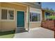 Welcoming front entrance with a vibrant green door and a cozy porch at 2181 S Troy Way # 103, Aurora, CO 80014
