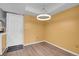 Bright entryway features wood floors, white door, and a modern halo light fixture at 2181 S Troy Way # 103, Aurora, CO 80014