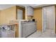 Kitchenette area with gray cabinets and countertops, white appliances, and white tile floors at 2181 S Troy Way # 103, Aurora, CO 80014