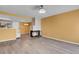 Open living room with hardwood floors, stone fireplace, and a modern light fixture at 2181 S Troy Way # 103, Aurora, CO 80014