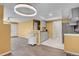 Open living space with wood floors, light grey kitchen, and entry to laundry room at 2181 S Troy Way # 103, Aurora, CO 80014