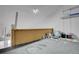 Storage area above garage with ladder, lighting, and storage containers at 2181 S Troy Way # 103, Aurora, CO 80014