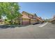 Exterior view of townhomes showing garages and well-maintained landscaping at 2181 S Troy Way # 103, Aurora, CO 80014