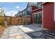 Charming backyard area with stone pavers, wooden fence, and patio at 285 Clementina St, Louisville, CO 80027