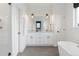 Bright and modern bathroom featuring double sinks, a soaking tub, and sleek fixtures at 285 Clementina St, Louisville, CO 80027