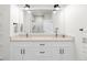 A spacious bathroom featuring a double sink vanity, modern fixtures, and a beautifully tiled shower at 285 Clementina St, Louisville, CO 80027