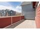 A wooden deck offers a view of the surrounding neighborhood and blue skies above at 285 Clementina St, Louisville, CO 80027