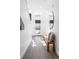 A welcoming foyer with light colored floors, bench, and a stylish mirror at 285 Clementina St, Louisville, CO 80027