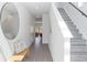 Bright foyer with wood floors, modern light fixtures, and a staircase at 285 Clementina St, Louisville, CO 80027