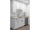 A stylish wet bar includes white cabinets, stone countertops, a sink, and a convenient beverage refrigerator at 285 Clementina St, Louisville, CO 80027