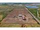 Vast aerial view of acreage property with home, outbuildings, and fenced yard near a highway at 3160 Bella Rosa Pkwy, Longmont, CO 80504