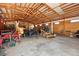 Large barn interior with wood beams and concrete flooring offers ample storage and workspace at 3160 Bella Rosa Pkwy, Longmont, CO 80504