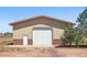 Barn exterior features a large garage door and a small walk-in door at 3160 Bella Rosa Pkwy, Longmont, CO 80504