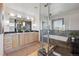 Modern bathroom featuring double sinks, granite counters, walk-in shower and soaking tub at 3160 Bella Rosa Pkwy, Longmont, CO 80504