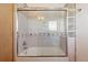 Tiled bathroom featuring a tub and shower combination with glass door at 3160 Bella Rosa Pkwy, Longmont, CO 80504