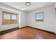 Bright bedroom features neutral walls, tile flooring, and two windows providing ample natural light and outside views at 3160 Bella Rosa Pkwy, Longmont, CO 80504