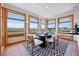Light-filled dining room with scenic views, seating for six and an adjacent breakfast bar at 3160 Bella Rosa Pkwy, Longmont, CO 80504