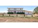 Front exterior view with tidy landscaping, mulch, and a red front door at 3160 Bella Rosa Pkwy, Longmont, CO 80504