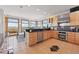 Sunlit kitchen featuring stainless steel appliances and natural wood cabinets, creating a warm cooking space at 3160 Bella Rosa Pkwy, Longmont, CO 80504