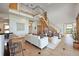 Spacious living area with open staircase, white sofa, stylish seating, and an elegant, modern design at 3160 Bella Rosa Pkwy, Longmont, CO 80504